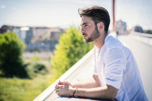 One handsome young man in urban setting in European city