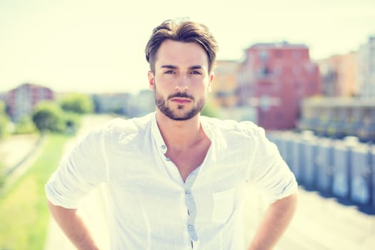 One handsome young man in urban setting in European city