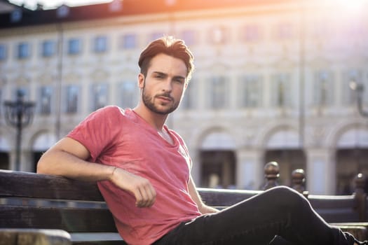 One handsome young man in urban setting in European city