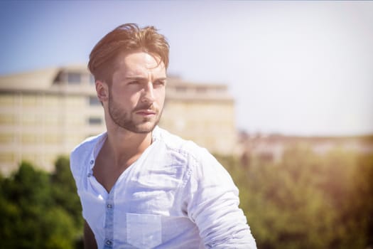 One handsome young man in urban setting in European city