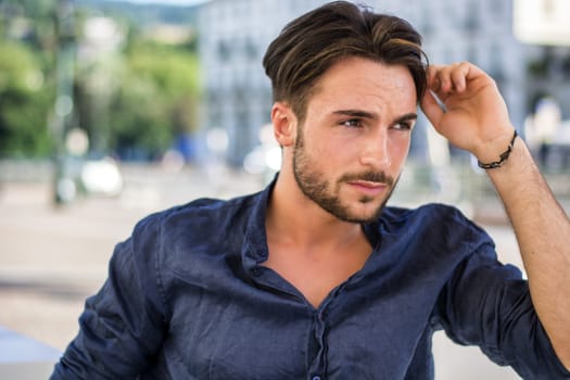 One handsome young man in urban setting in European city