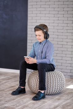 Relax and listening music concept. European boy fill the bit. Portrait of head in headphones with closed eyes. Boy in casual wear.