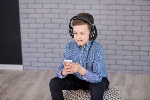 Relax and listening music concept. European boy fill the bit. Portrait of head in headphones with closed eyes. Boy in casual wear.