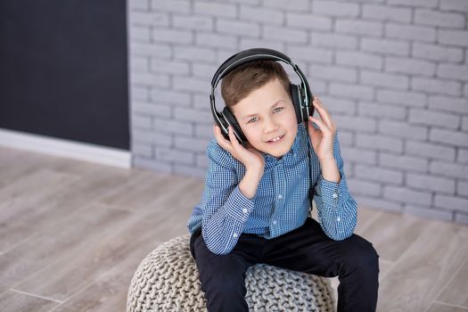 Relax and listening music concept. European boy fill the bit. Portrait of head in headphones with closed eyes. Boy in casual wear.