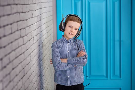 Relax and listening music concept. European boy fill the bit. Portrait of head in headphones with closed eyes. Boy in casual wear.