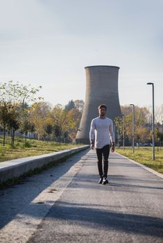 One handsome young man in urban setting in European city, standing