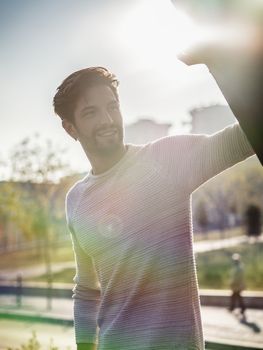 One handsome young man in urban setting in European city, standing