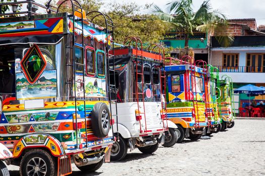 Motor-tricycles decorated as traditional Colombian chivas at the colorful Guatape city.