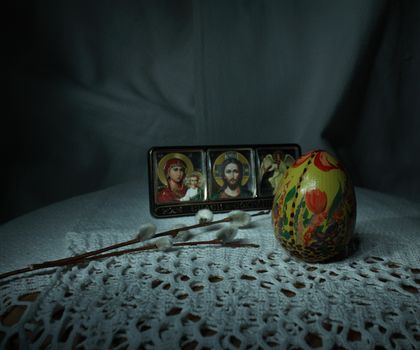 Easter Painted egg with willow twig next to the icon, Easter theme