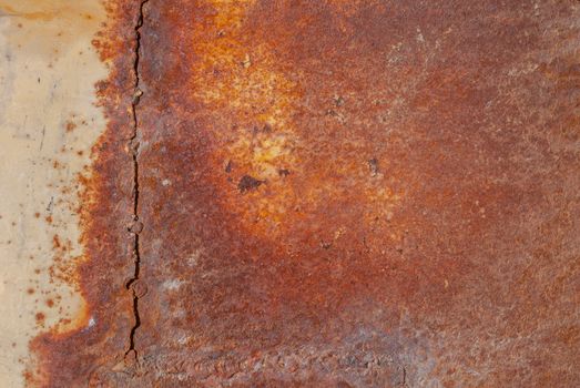 rusty iron surface covered with old chipped yellow color paint, which has long been influenced by different climatic conditions