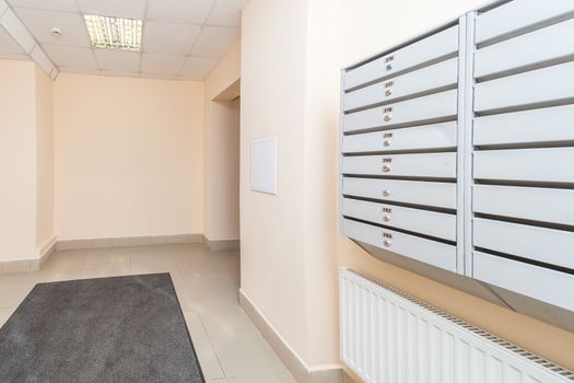 Empty hall mailboxes and doors at new apartment building