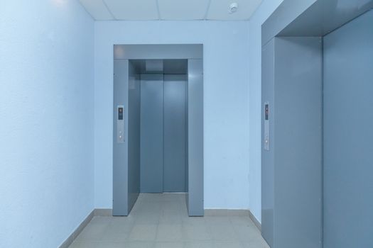 empty modern elevator or lift with closed metal doors