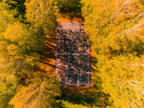 Aerial view of basketball field on day time in forest. Above with drone. Volleyball