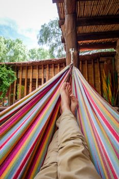 Man relaxing in a colored hammock. subjective view