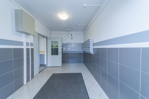 Empty hall mailboxes and doors at new apartment building