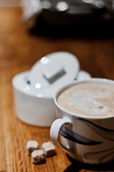 Fresh and tasty coffee in the kitchen on the wooden board. Drink concept.