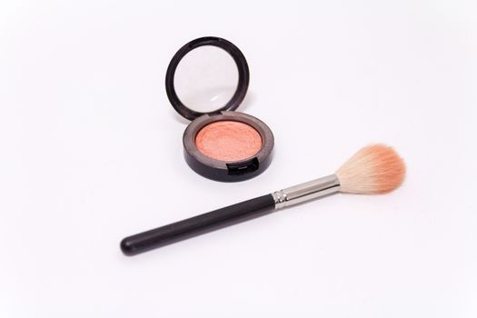 Close up of makeup brush and blush box isolated on white background.