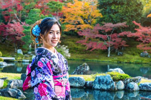 Asian woman wearing japanese traditional kimono in autumn park. Japan