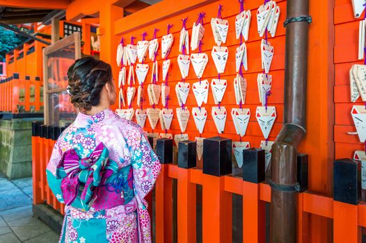 Asian women wearing japanese traditional kimono visiting the beautiful in Fushimi Inari Shrine in Kyoto, Japan