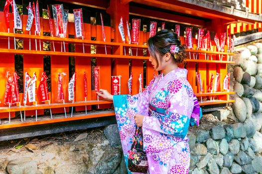 Asian women wearing japanese traditional kimono visiting the beautiful in Fushimi Inari Shrine in Kyoto, Japan