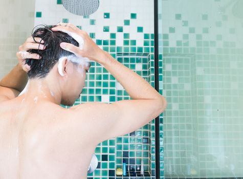 Closeup men washing hair and taking a shower in the bathroom, health care and medical concept