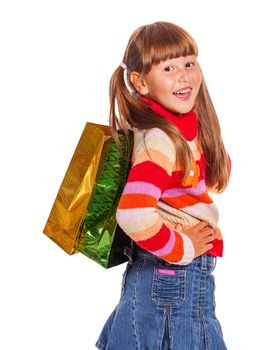 Smiling six years Girl holding presents bags isolated