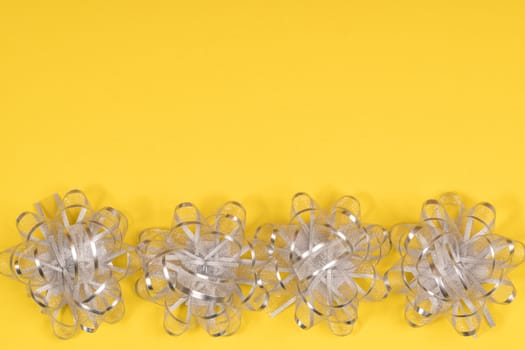 decorative silver bows on a colored background