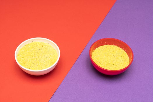 cornmeal the bowls on a colored background