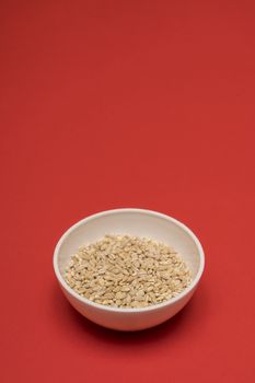 pearl barley a bowl on a colored background