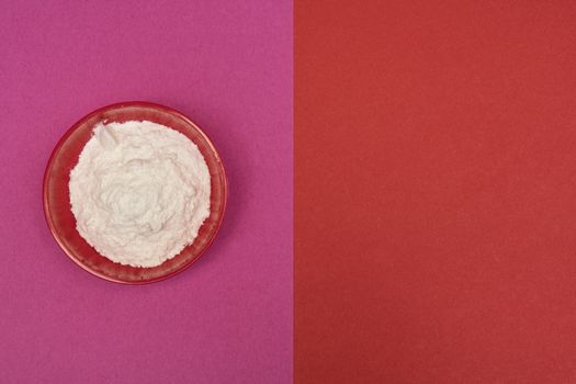 flour in a bowl on a colored background
