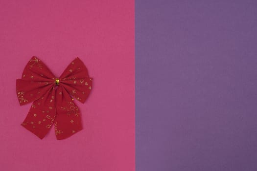A decorative christmas bow on a colored background