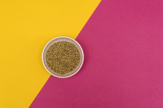 lentils in a bowl on a colored background