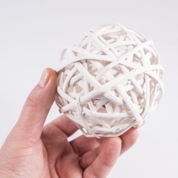 a ball made with white wooden slats on the hand