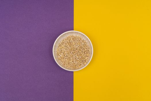 pearl barley a bowl on a colored background