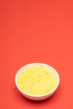 cornmeal a bowl on a colored background