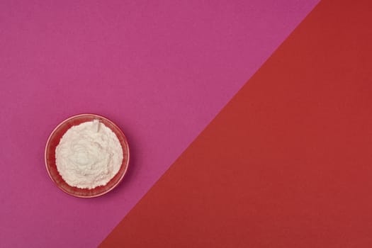 flour in a bowl on a colored background