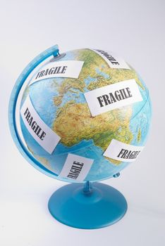 a globe with fragile writings