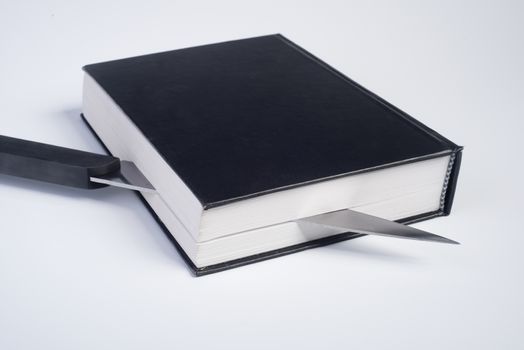 a black book cut with a knife