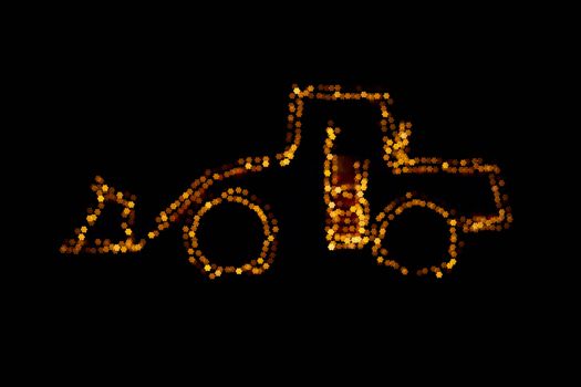 Blurred wheel loader decorated with lights star bokeh lights on a wheel loader