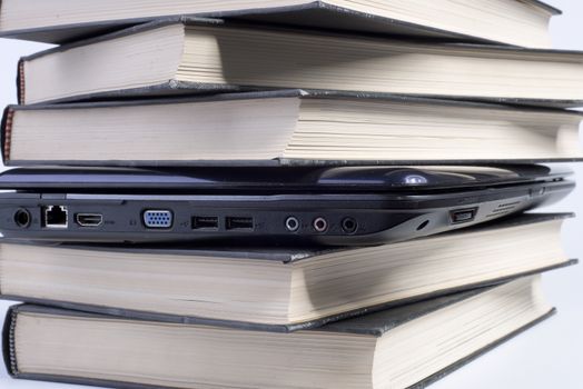 a laptop between the books