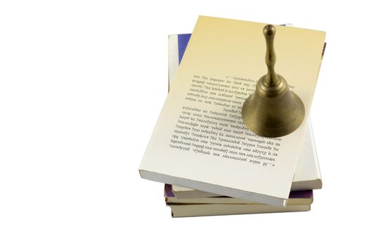 old bell with stack of books