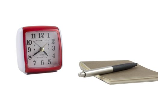 clock with notebook and a pen