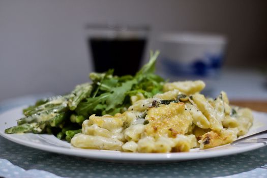 Delicious italian fresh pasta on a white plate in the kitchen. Food concept.