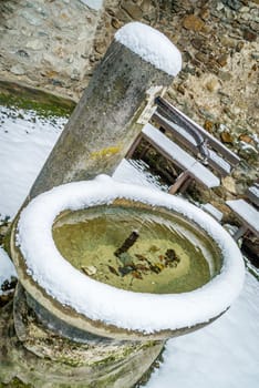 Frozen fountain under heavy snow in the winter