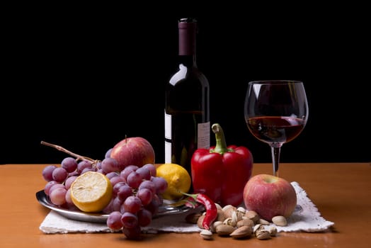 fruits, vegetables and a bottle of red wine on the table