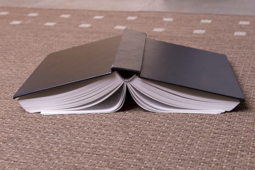 A book open on floor on the carpet