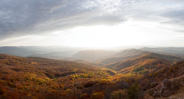 Panorama. Sunset sky above the autumn mountains.