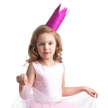 Happy small princess girl in pink dress and crown isolated on white background