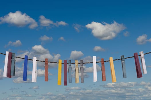 some colored clothespins on a thread to dry