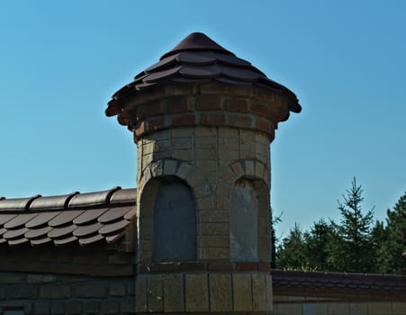 Small brick tower on monastery fence